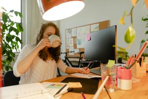 Woman drinking from a ceramic mug